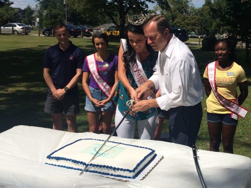 Crystal Byrd, Miss Fayetteville, gives Mayor Nat Robertson a hand cutting one of the two birthday cakes at the Museum of the Cape Fear’s Festival of Yesteryear during the annual Lafayette Birthday Celebration. Over 200 people enjoyed cake and ice cream as Fayetteville celebrated their namesake’s 260th birthday.